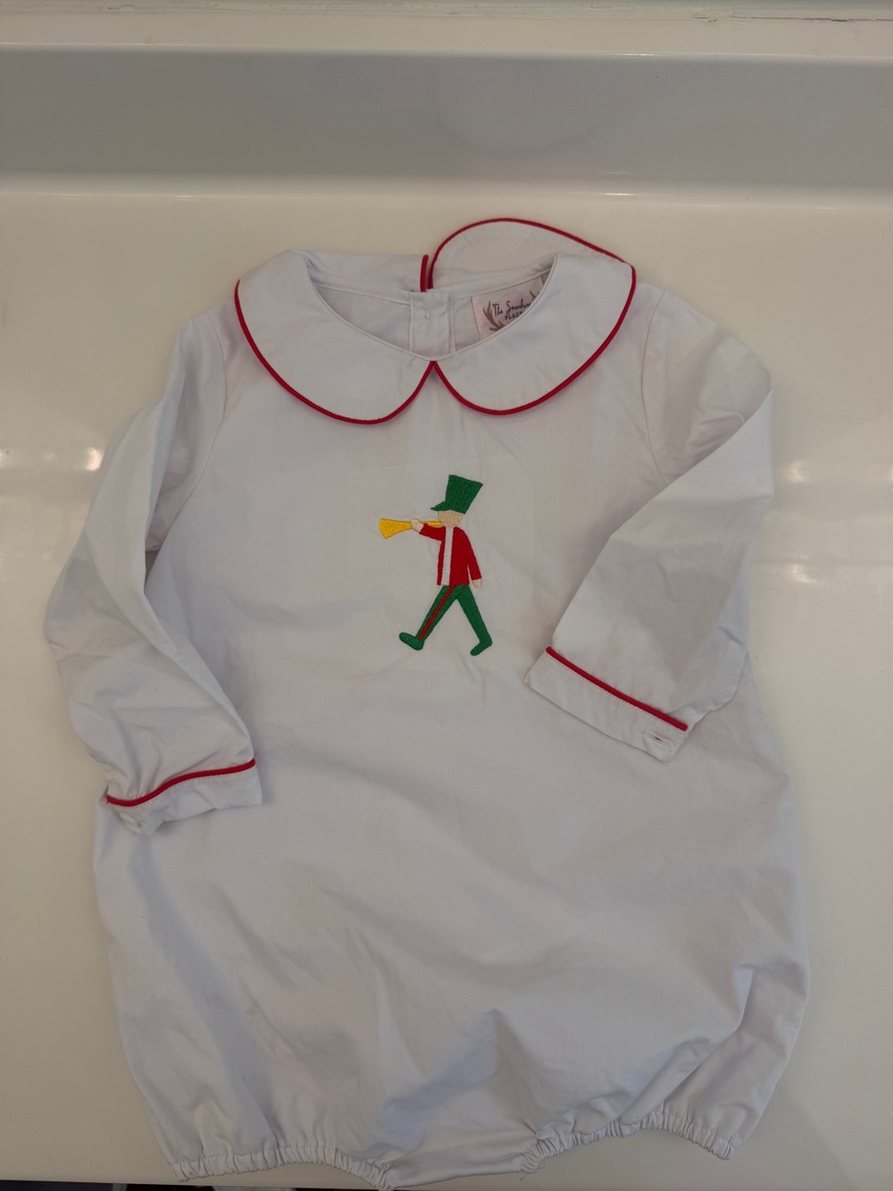 White Bubble Romper with Red Trim and Embroidered Toy Soldier